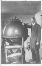 SA1708.52 - Photo shows a cauldron in the medicine house; Alonzo is standing beside it. Identified on the back.